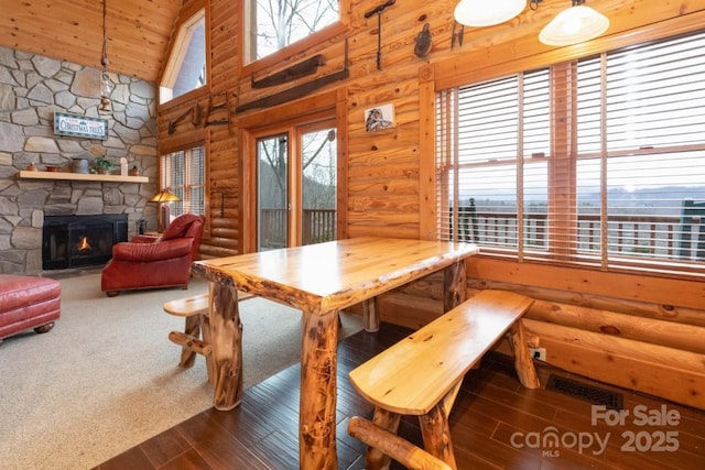 175 Owl Lookout Rd, Sylva, NC 28779 - dining area featuring wood ceiling, rustic walls, high vaulted ceiling, dark hardwood / wood-style floors, and a stone fireplace