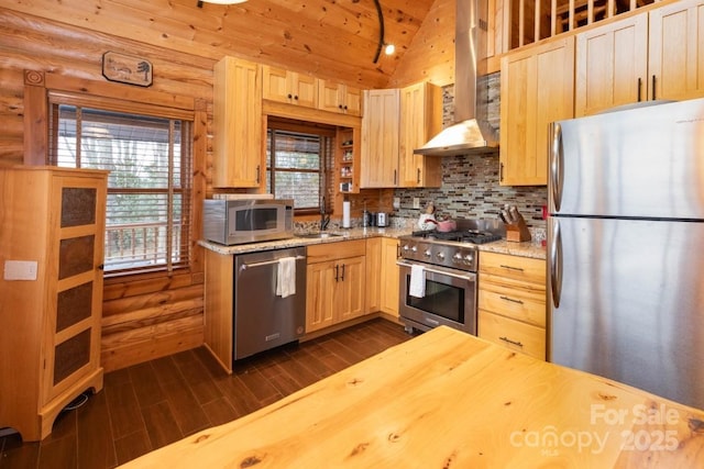 175 Owl Lookout Rd, Sylva, NC 28779 - kitchen featuring lofted ceiling, wall chimney range hood, appliances with stainless steel finishes, light stone counters, and light brown cabinets