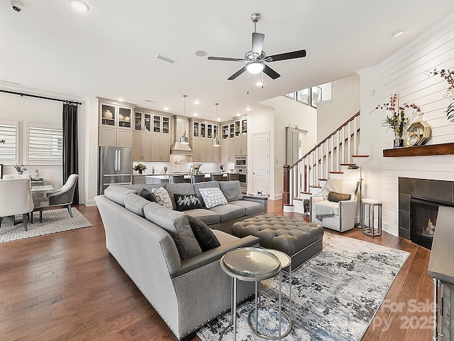 living room featuring dark hardwood / wood-style floors and ceiling fan