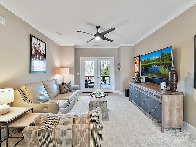 carpeted living room featuring ornamental molding, ceiling fan, and french doors