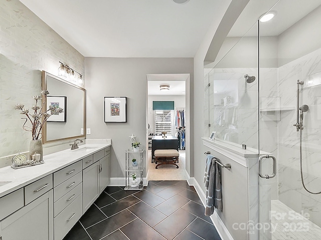 bathroom with vanity, tile patterned flooring, and a shower with shower door