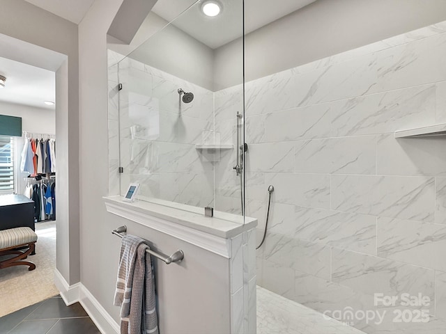 bathroom featuring a tile shower