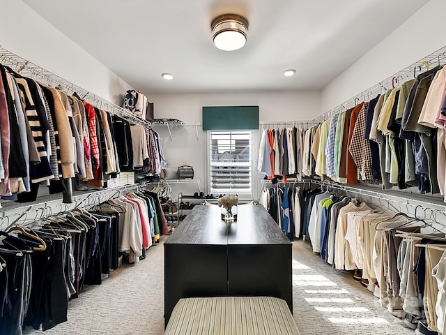 walk in closet featuring light colored carpet