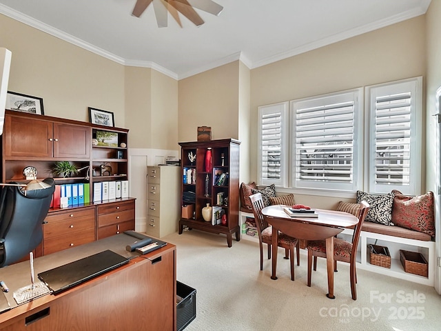 carpeted home office featuring crown molding and ceiling fan