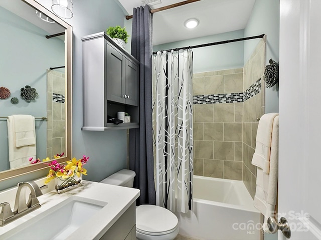 full bathroom featuring vanity, shower / bath combination with curtain, and toilet