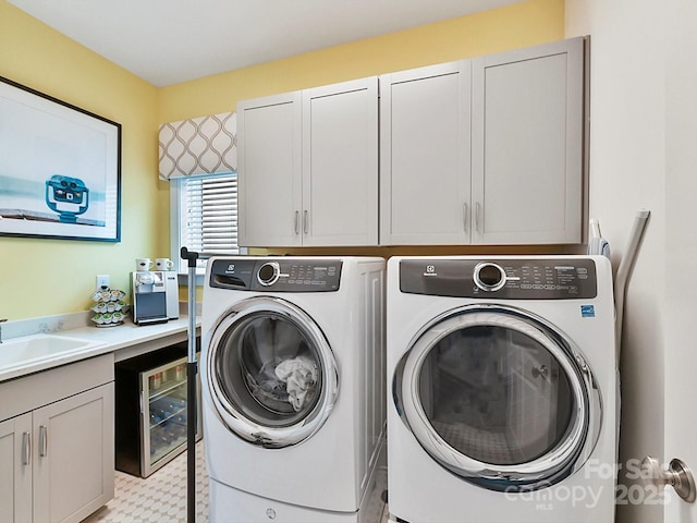 laundry room featuring sink, washer and clothes dryer, beverage cooler, and cabinets