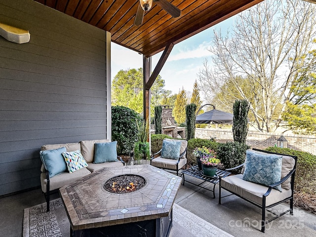 view of patio / terrace featuring ceiling fan, an outdoor fireplace, and an outdoor fire pit