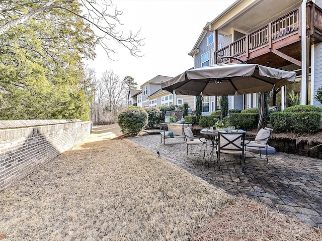 view of yard featuring a balcony and a patio area