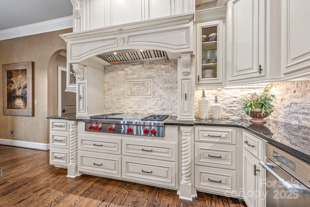 kitchen featuring white cabinetry, dark stone countertops, dark hardwood / wood-style floors, ornamental molding, and stainless steel gas cooktop