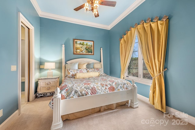 carpeted bedroom with ceiling fan and ornamental molding