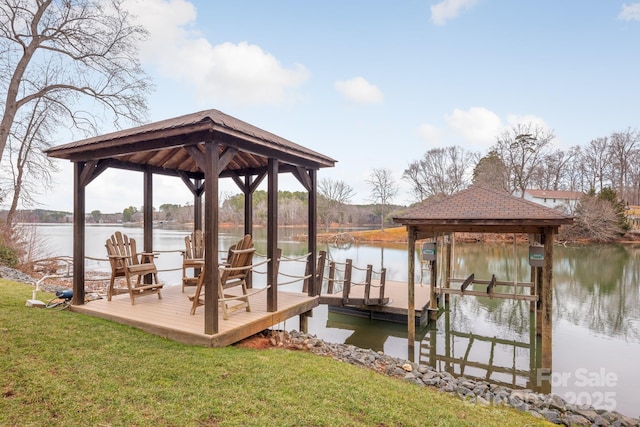 dock area with a water view, a yard, and a gazebo