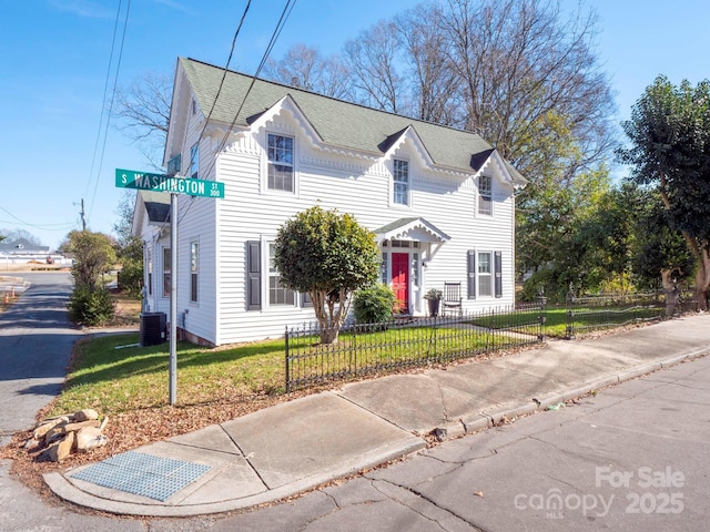 view of front of property featuring central AC unit and a front lawn