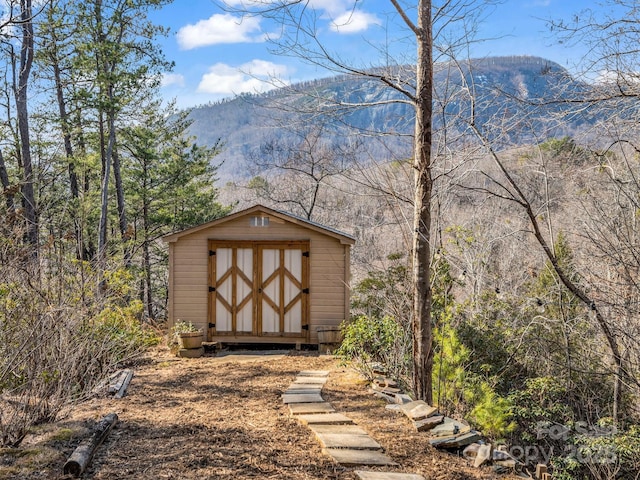 view of outbuilding with a mountain view