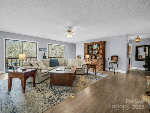 living room with hardwood / wood-style floors, a textured ceiling, and ceiling fan