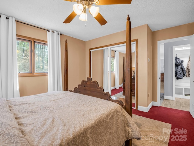 bedroom featuring multiple windows, ceiling fan, a closet, and a textured ceiling