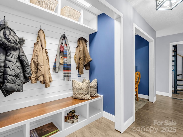 mudroom featuring hardwood / wood-style flooring and a textured ceiling