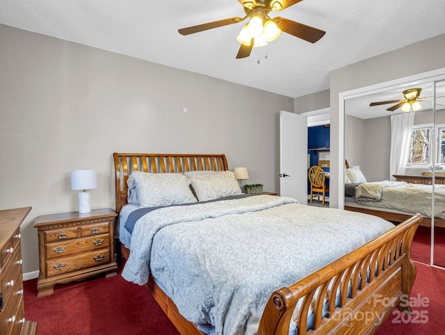 carpeted bedroom featuring ceiling fan, a closet, and a textured ceiling