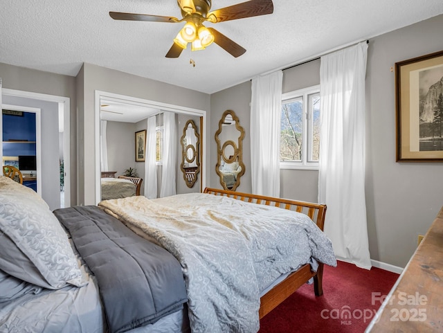 carpeted bedroom featuring ceiling fan, a textured ceiling, and a closet