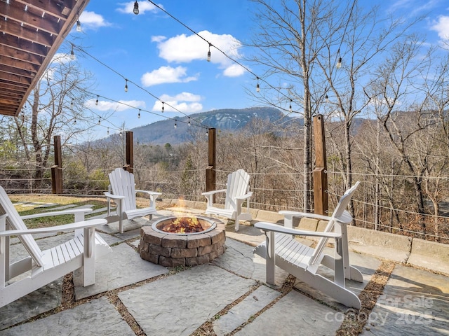 view of patio featuring a mountain view and an outdoor fire pit