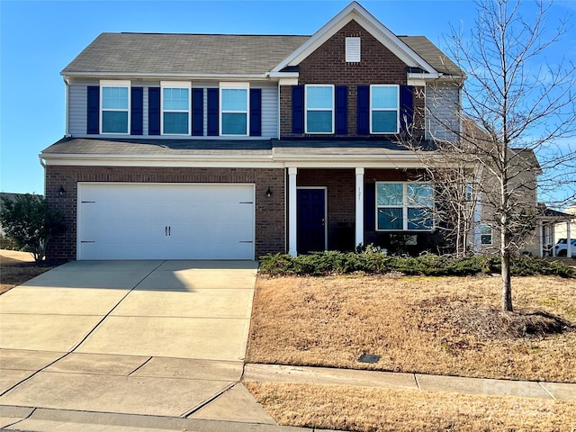 view of front of home with concrete driveway, brick siding, and an attached garage