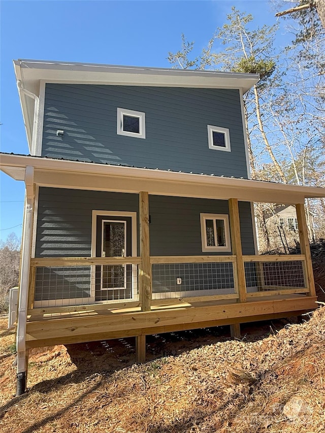 rear view of property with covered porch