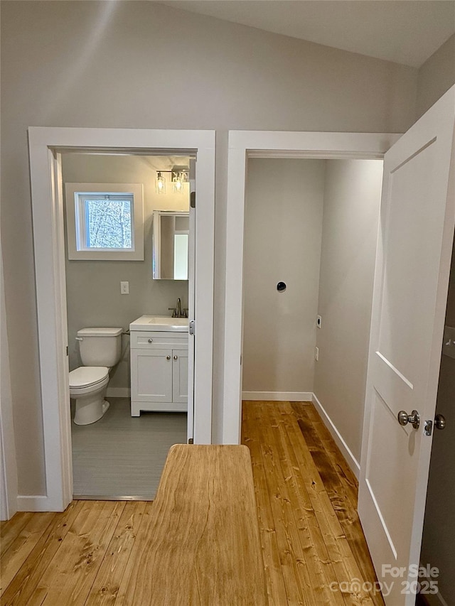 bathroom featuring vanity, hardwood / wood-style floors, and toilet