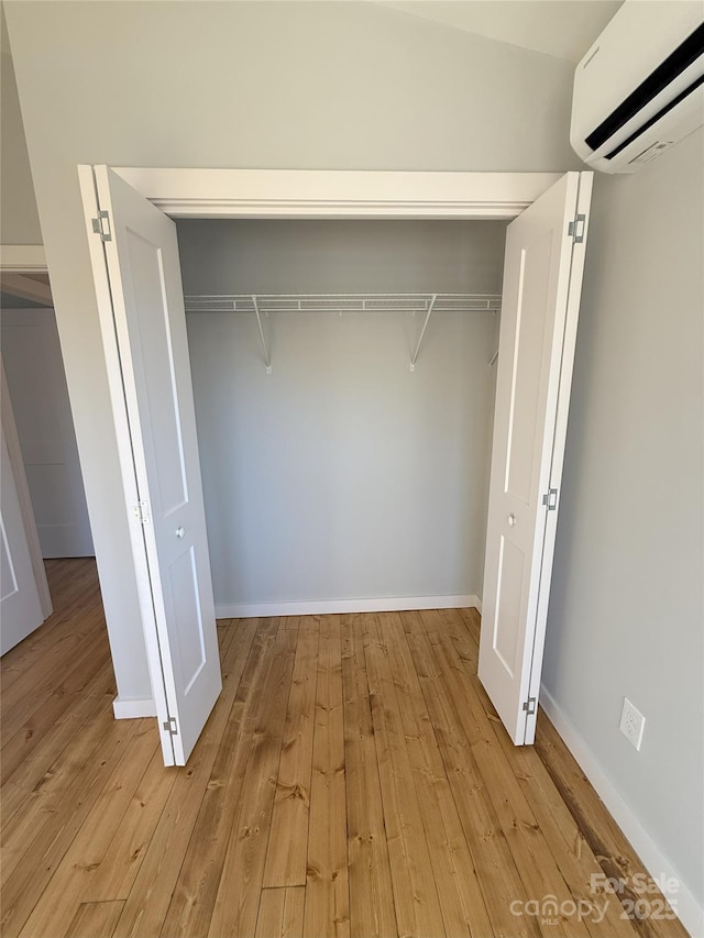 closet with a wall mounted air conditioner