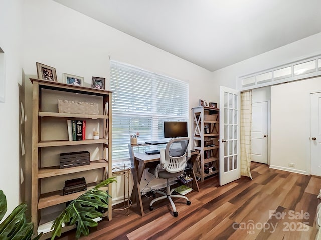 home office with dark wood-type flooring and french doors