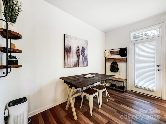 dining space with dark hardwood / wood-style floors