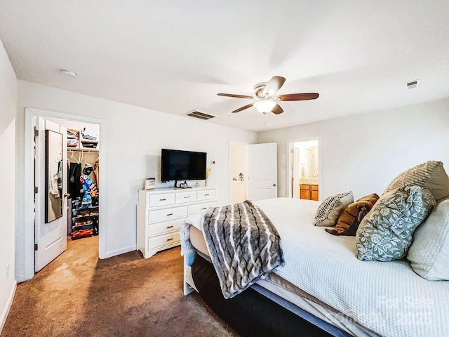 carpeted bedroom featuring ceiling fan, a walk in closet, connected bathroom, and a closet