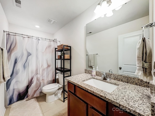 bathroom with vanity, tile patterned floors, and toilet