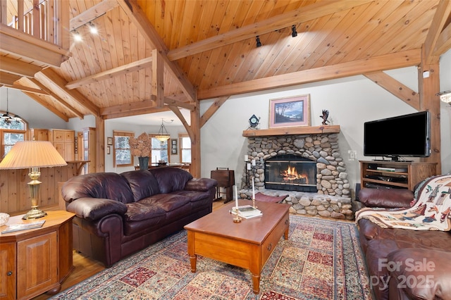 living room with wood-type flooring, a stone fireplace, vaulted ceiling with beams, and wooden ceiling