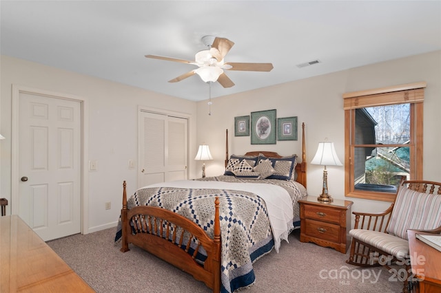 carpeted bedroom with ceiling fan and a closet