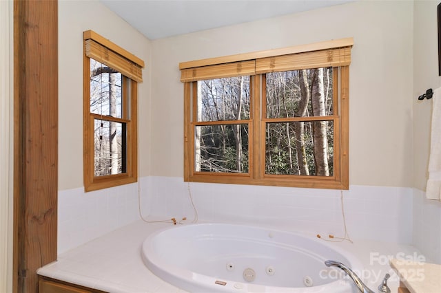 bathroom with a relaxing tiled tub