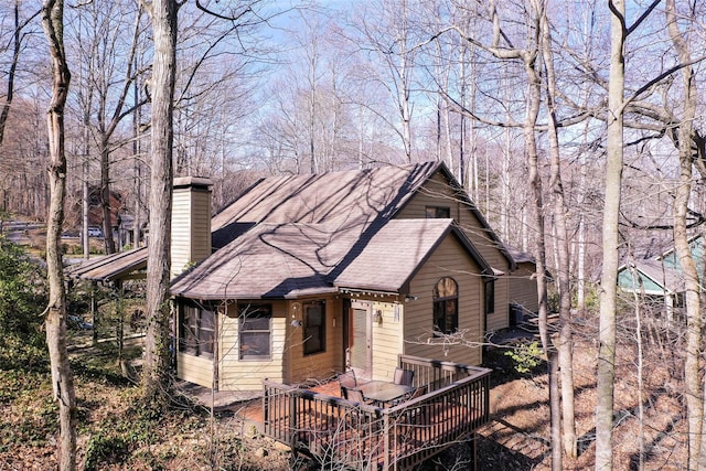 view of front of property featuring a wooden deck and a sunroom