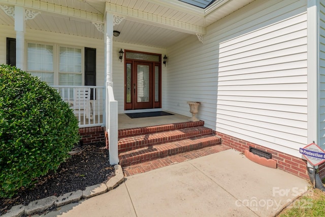 doorway to property featuring covered porch