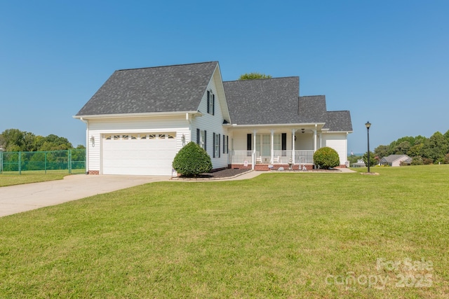 view of front of property featuring a garage, covered porch, and a front lawn