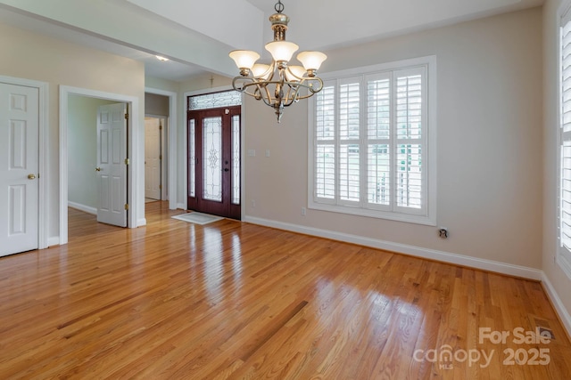 entrance foyer featuring a chandelier and light hardwood / wood-style flooring