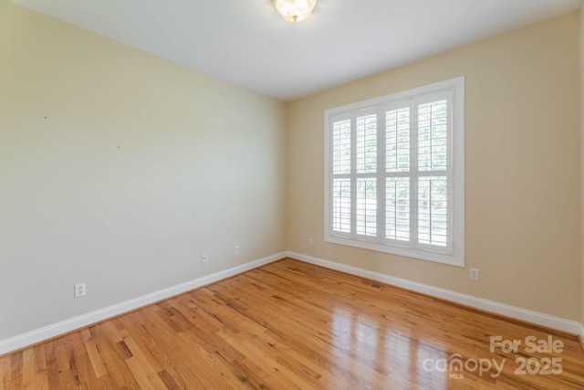 unfurnished room with light hardwood / wood-style floors