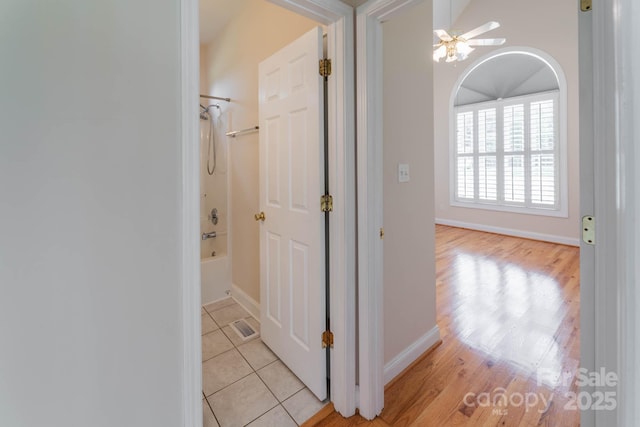 corridor featuring light tile patterned floors