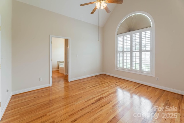 unfurnished room with high vaulted ceiling, light hardwood / wood-style floors, and ceiling fan