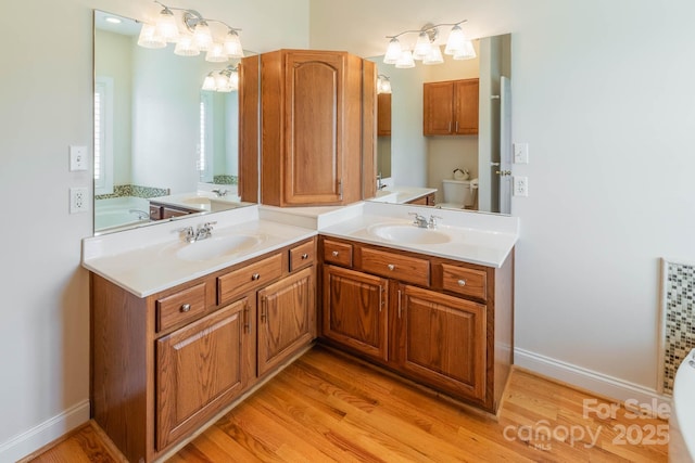 bathroom featuring vanity, toilet, and hardwood / wood-style floors