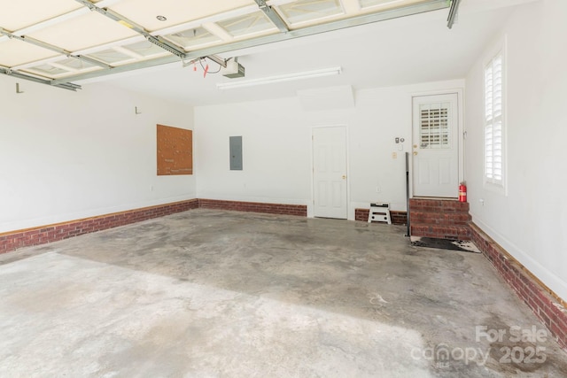 garage featuring a garage door opener and electric panel