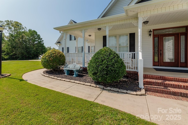 property entrance featuring a yard and a porch