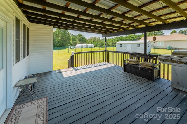 deck featuring a storage shed and a yard