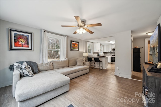 living room featuring hardwood / wood-style flooring and ceiling fan