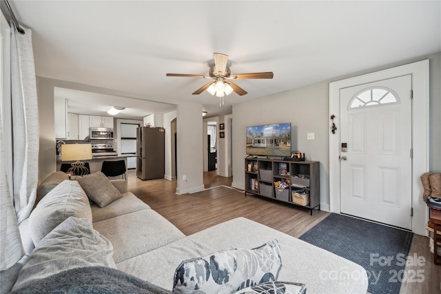 living room featuring ceiling fan and hardwood / wood-style floors