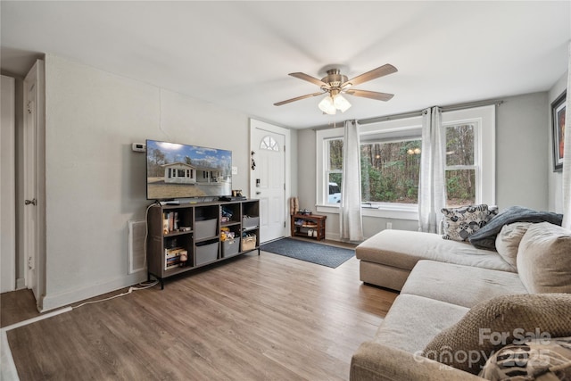 living room with ceiling fan and hardwood / wood-style floors