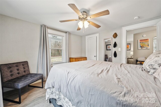 bedroom with ceiling fan and light wood-type flooring