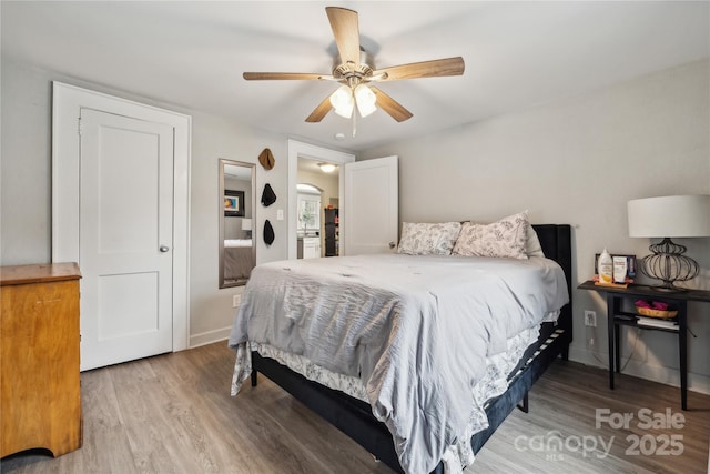 bedroom with ceiling fan and hardwood / wood-style floors